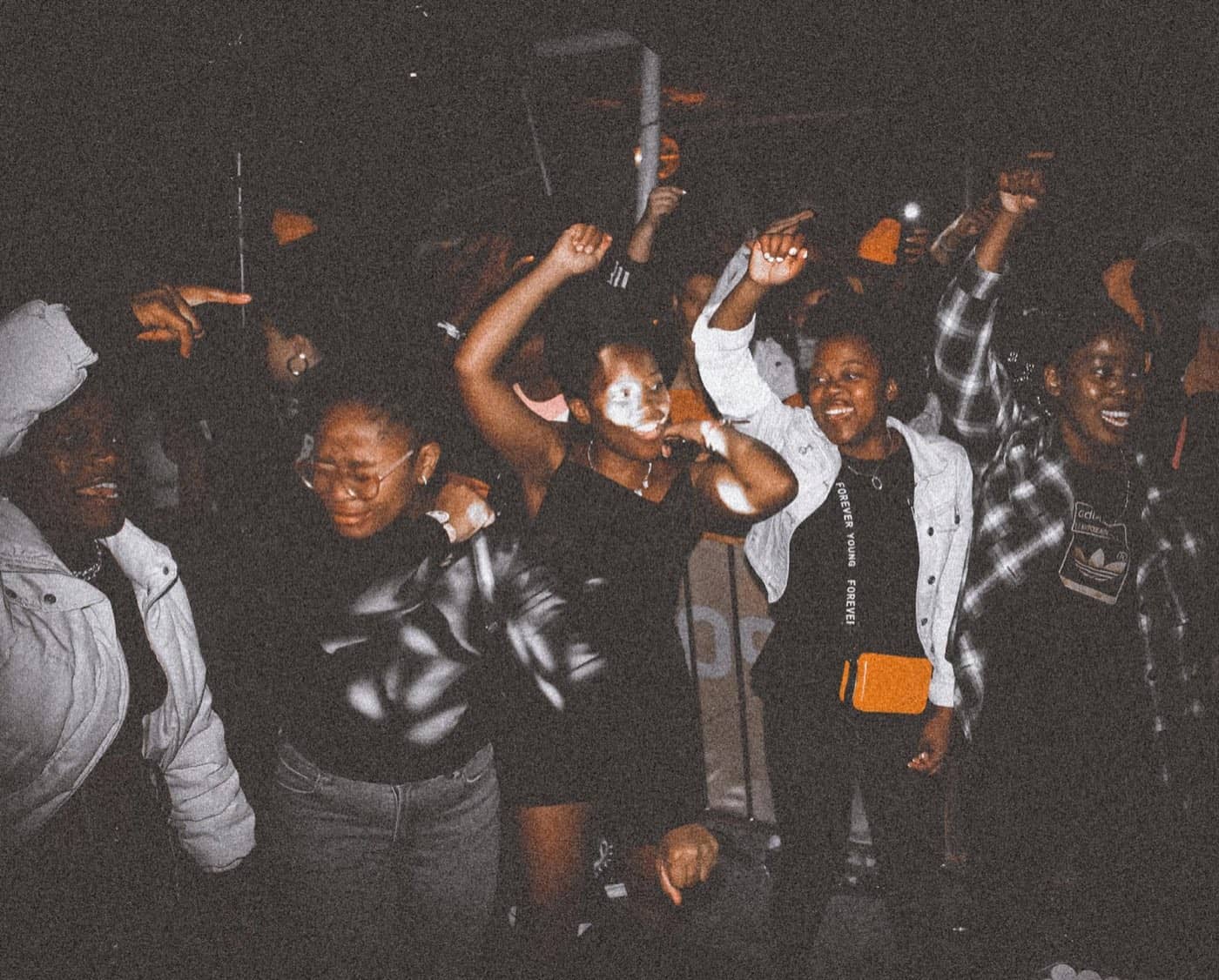 A young crowd dancing at a concert